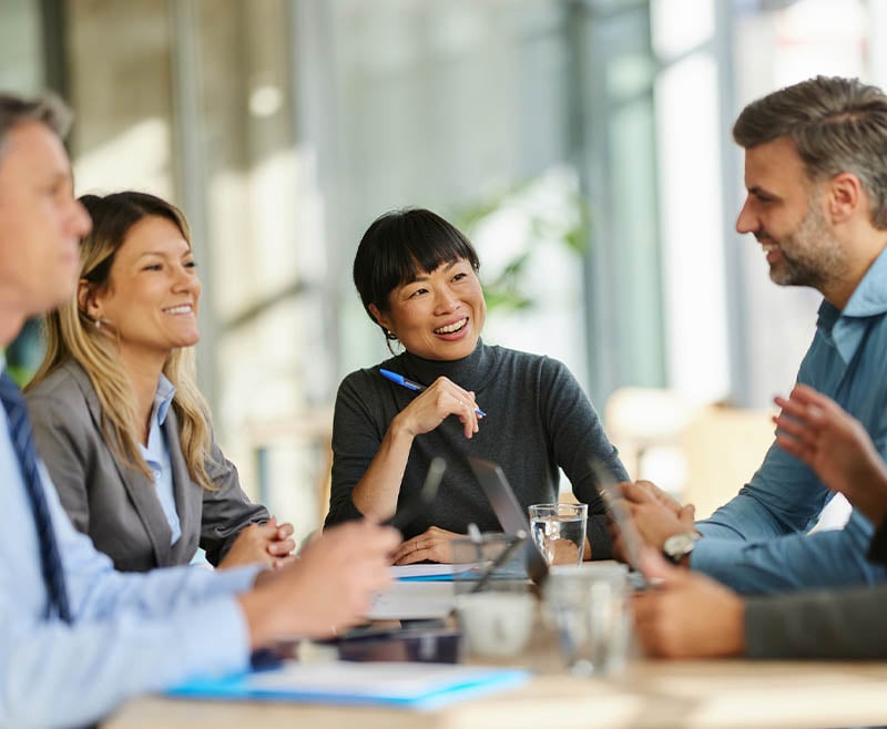 A group of people talking and smiling.