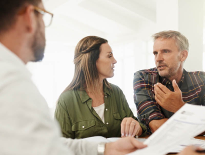 A group of people discussing finances.