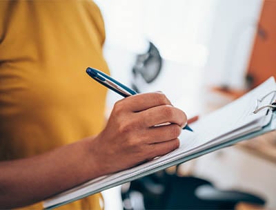 A person reviewing a checklist.