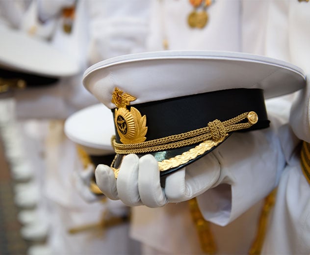 Someone holding a military hat.