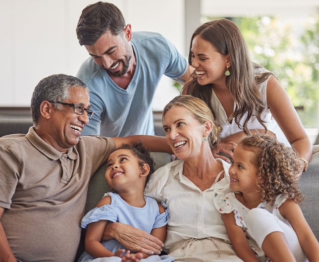 A multi-generational family laughing together.