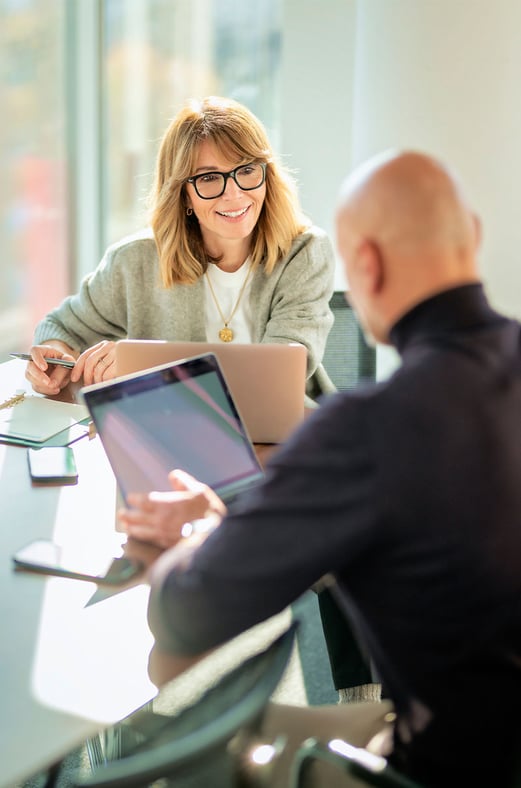 Two people having a discussion at a table.