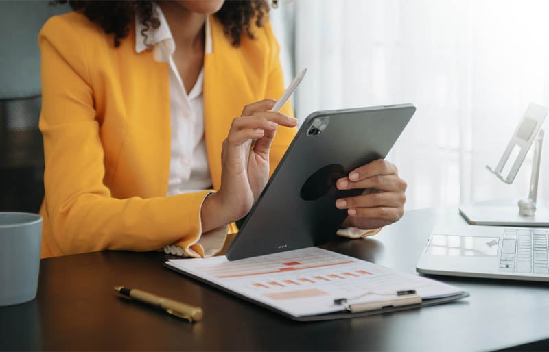 A woman working on her tablet.